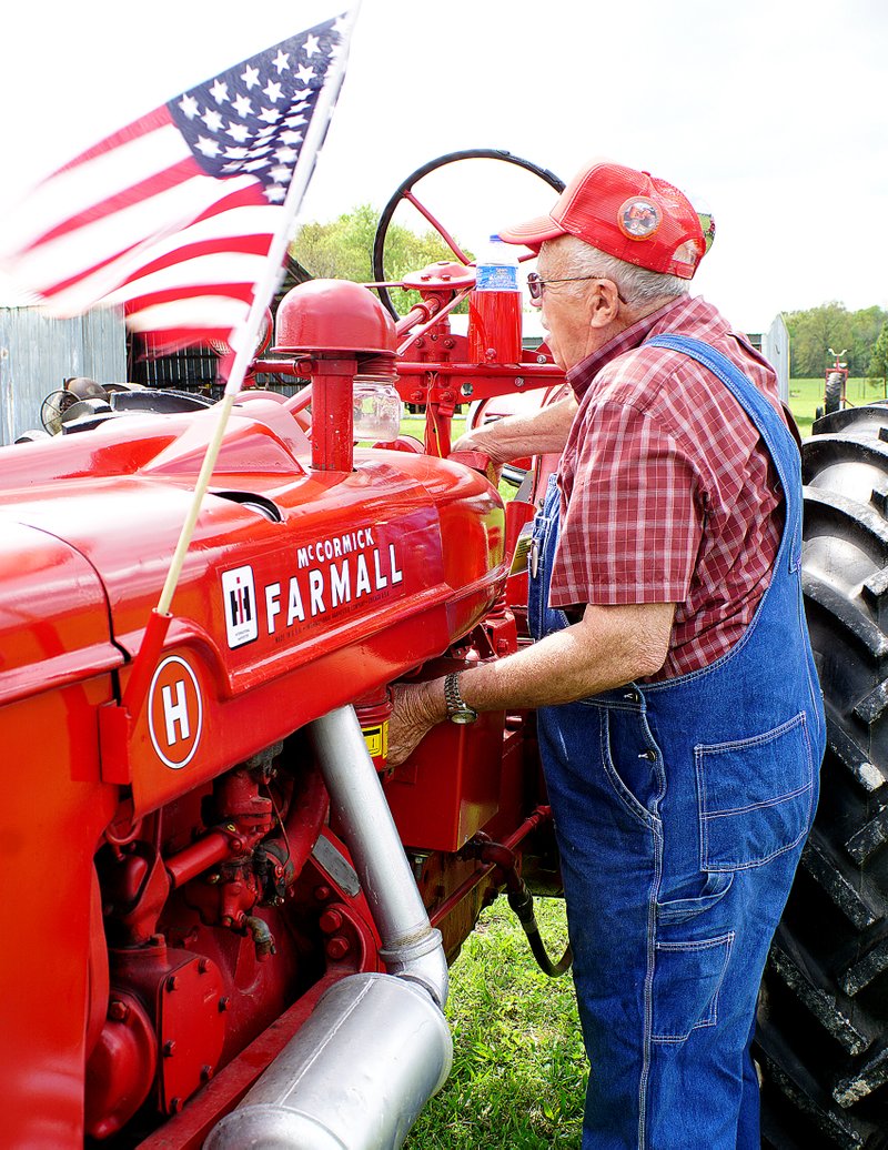 Photo by Randy Moll Don Christensen of Gentry starts up his 1948 Farmall, Model H, just before the parade of power at the Tired Iron of the Ozarks spring show on Friday in Gentry. For more photos and a story, see Page B8.