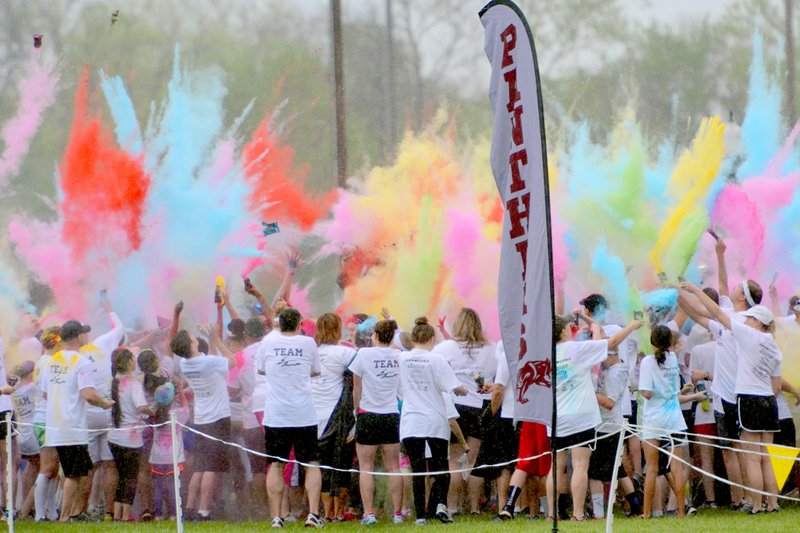 Bud Sullins/Special to the Herald-Leader Colors go flying before the start of the Panther Powder Run held Saturday on the grounds of Simmons Foods. The race was a fundraiser for the Siloam Springs track program.