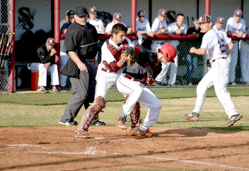 Graham Thomas/Herald-Leader Siloam Springs catcher Dodge Pruitt tags out Russellville runner Garrett Freeman in the third inning Monday at James Butts Baseball Complex. The Cyclones defeated the Panthers 12-6 in a 7A/6A-Central Conference game.