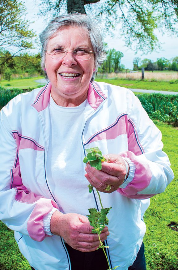 Naturalist Shirley Pratt points out the beneficial aspects of deadnettle, a native plant that grows in her garden in the Happy Valley neighborhood of the Centerville community near Greenbrier. Pratt will be the guest speaker at the Faulkner County Historical Society’s annual program on April 30. 