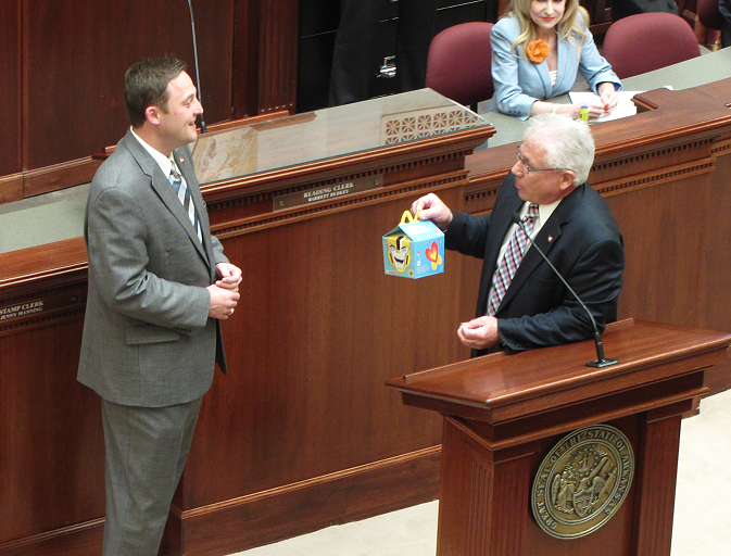 House Speaker Jeremy Gillam, R-Judsonia, is presented with a gift card jokingly encased in a Happy Meal box Wednesday.