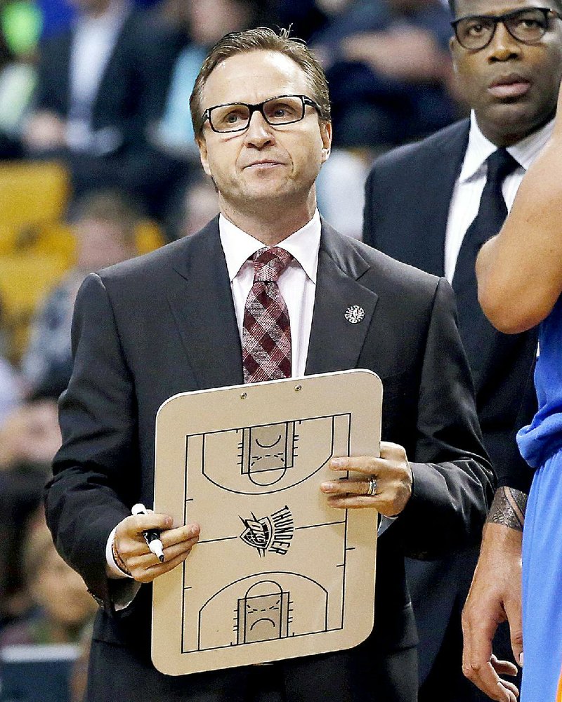 In this Nov. 12, 2014, file photo, Oklahoma City Thunder coach Scott Brooks holds a marker board during a timeout in the first half of an NBA basketball game against the Boston Celtics in Boston. The Thunder fired Brooks on Wednesday, April 22, 2015. 