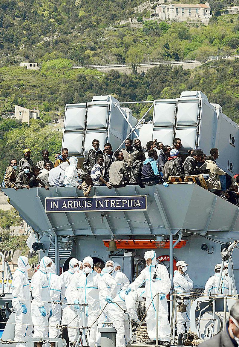 Some of the 540 people rescued by the Italian navy vessel Chimera wait to disembark Wednesday in Salerno, Italy. A number of the foreigners had to be isolated on the ship because of scabies. 