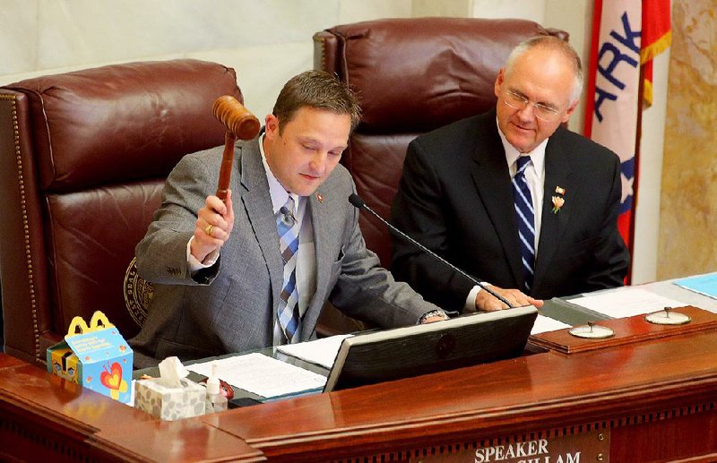 Arkansas House Parliamentarian Buddy Johnson (right) watches as Speaker Jeremy Gillam, R-Judsonia, bangs his gavel, officially ending the 2015 regular session, which included passage of a tax cut and reauthorization of the private option to provide private health insurance for poor Arkansans. 