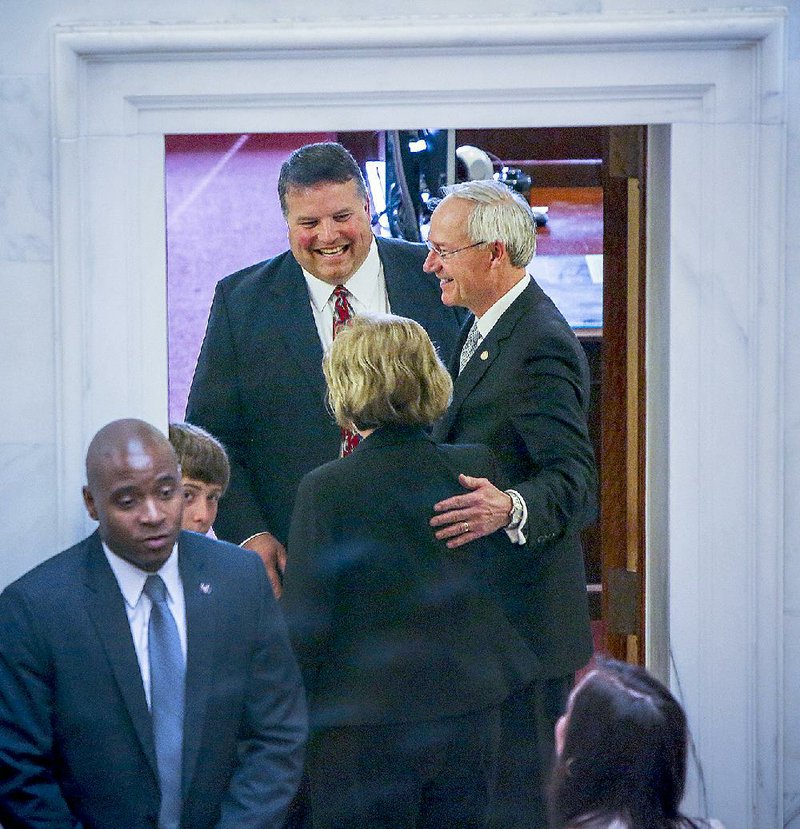 Sen. Greg Standridge (top left), R-Russellville, greets guests Wednesday, April 22, 2015, as he chats with Gov. Asa Hutchinson in a room just off the Senate floor. Shortly after the photo was taken, Standridge, who won a special election last week, took the oath of office. 