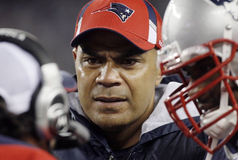 In this Nov. 22, 2009, file photo, New England Patriots linebacker Junior Seau, center, talks to teammates on the sidelined during an NFL football game against the New York Jets in Foxborough, Mass. A federal judge has approved Wednesday, April 22, 2015, a plan to resolve thousands of NFL concussion lawsuits that could cost the league $1 billion over 65 years. Critics contend the NFL is getting off lightly given annual revenues of about $10 billion About 200 NFL retirees or their families, including Seau's, have rejected the settlement and plan to sue the league individually. 
