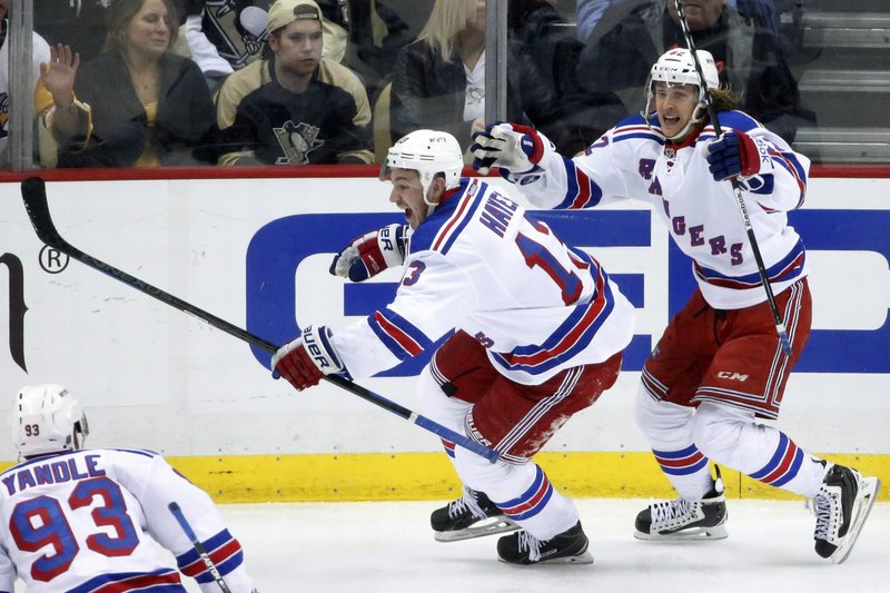 New York Rangers' Kevin Hayes (13) celebrates his game-winning overtime goal with teammate Carl Hagelin (62) during overtime in a first-round NHL playoff hockey game in Pittsburgh on Wednesday, April 22, 2015. The Rangers won 2-1 to take a 3-1 lead in the best-of-seven series. 