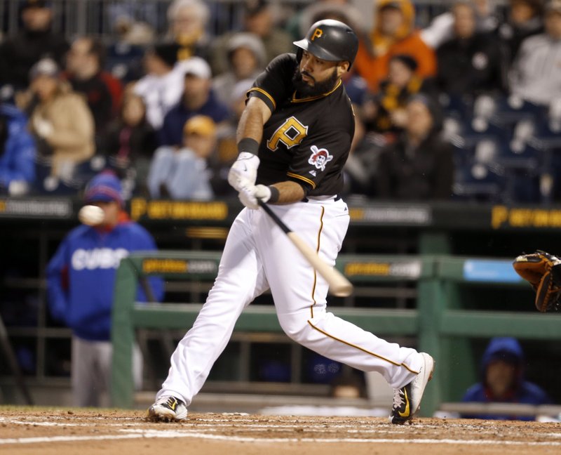 Pittsburgh Pirates' Pedro Alvarez (24) hits a sacrifice fly to right field with the bases loaded in the third inning of a baseball game against the Chicago Cubs on Wednesday, April 22, 2015, in Pittsburgh. The fly drove in Andrew McCutchen with a run.