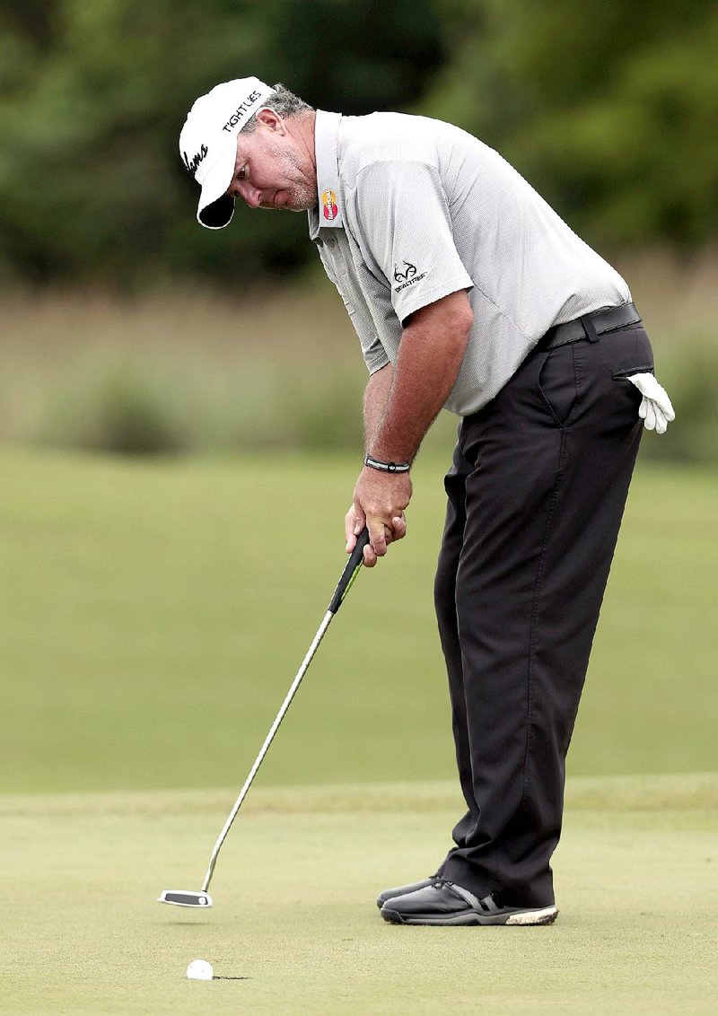 Boo Weekley sinks a putt on the 13th hole during the first round of the Zurich Classic PGA golf tournament, Thursday, April 23, 2015, in Avondale, La. (AP Photo/Butch Dill)