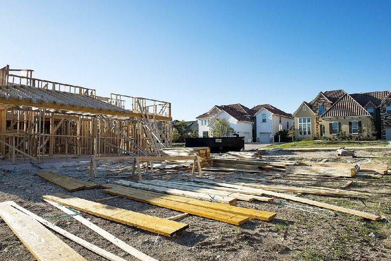 A new home stands under construction in the Reserve neighborhood of the Toll Brothers Inc. The Dominion gated community in San Antonio, Texas, U.S., on Saturday, March 28, 2015. More Americans than forecast signed contracts to purchase previously owned homes in February, indicating a pickup in the housing market ahead of the spring selling season. Photographer: Matthew Busch/Bloomberg
