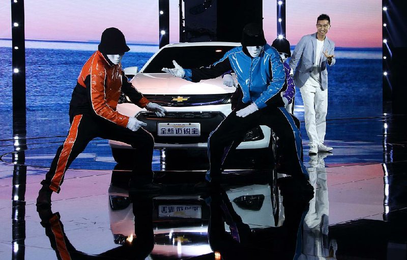Dancers perform in front of the Chevrolet Malibu vehicle, produced by General Motors Co. (GM), during a media event ahead of the 16th Shanghai International Automobile Industry Exhibition (Auto Shanghai 2015) in Shanghai, China, on Sunday, April 19, 2015. The Auto Shanghai 2015 will be held April 22-29. Photographer: Tomohiro Ohsumi/Bloomberg