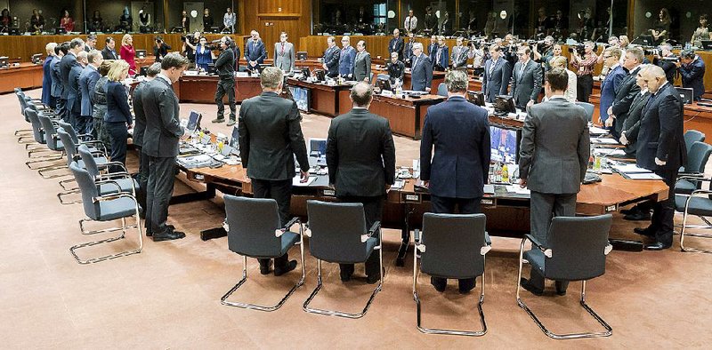 European Union heads of state observe a moment of silence during a round table at an emergency EU summit in Brussels on Thursday, April 23, 2015. EU leaders are facing calls from all sides to take emergency action to save lives in the Mediterranean, where hundreds of migrants are missing and feared drowned in recent days. (AP Photo/Geert Vanden Wijngaert)
