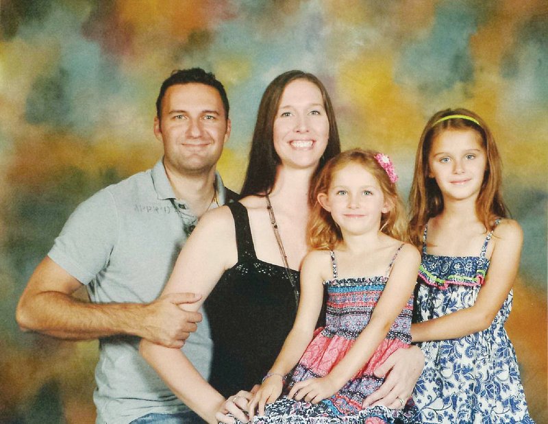 Daniel Wassom II is pictured with his wife, Suzanne, and their two daughters, Lorelai, seated, now 6, and Sydney, now 8. Daniel Wassom was killed in the April 27, 2014, tornado as he knelt over Lorelai in the hallway of their home in Vilonia. The family’s home in Parkwood Meadows was destroyed, and Suzanne has donated the lot to the city of Vilonia. The property will be turned into a memorial park dedicated to Wassom and the seven other Vilonia tornado victims. “It just seems like it’s been a couple of months. … It doesn’t seem like it’s been a year,” Suzanne said.