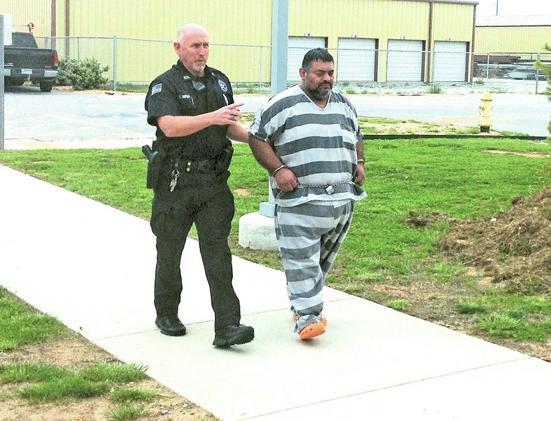 NWA Democrat-Gazette/TRACY NEAL Mauricio Torres, 45, is escorted into court Thursday by a Benton County Sheriff&#8217;s Office deputy.
