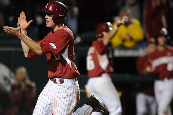 Clark Eagan of Arkansas celebrates after scoring the go-ahead run against Mississippi State during the eighth inning Friday, April 24, 2015, at Baum Stadium in Fayetteville. 