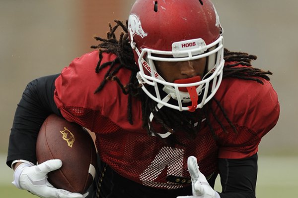 Keon Hatcher of Arkansas works through a drill during practice Saturday, April 18, 2015, at the university's practice facility in Fayetteville.