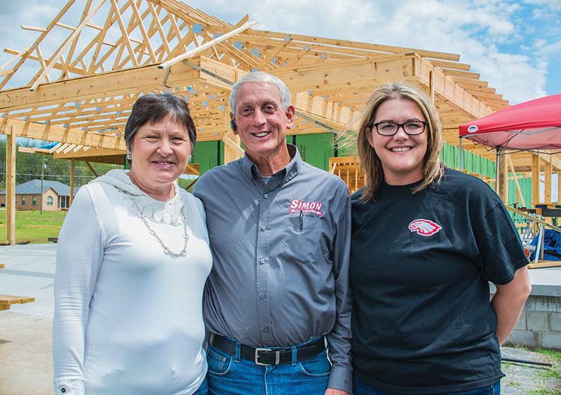 Karen and Rick Simon, with their daughter-in-law, Rebecca Simon, stand outside their new home on Tower Road in the Saltillo community. Karen and Rick are rebuilding on the same foundation where their house stood before it was completely destroyed by a tornado on April 27, 2014. 