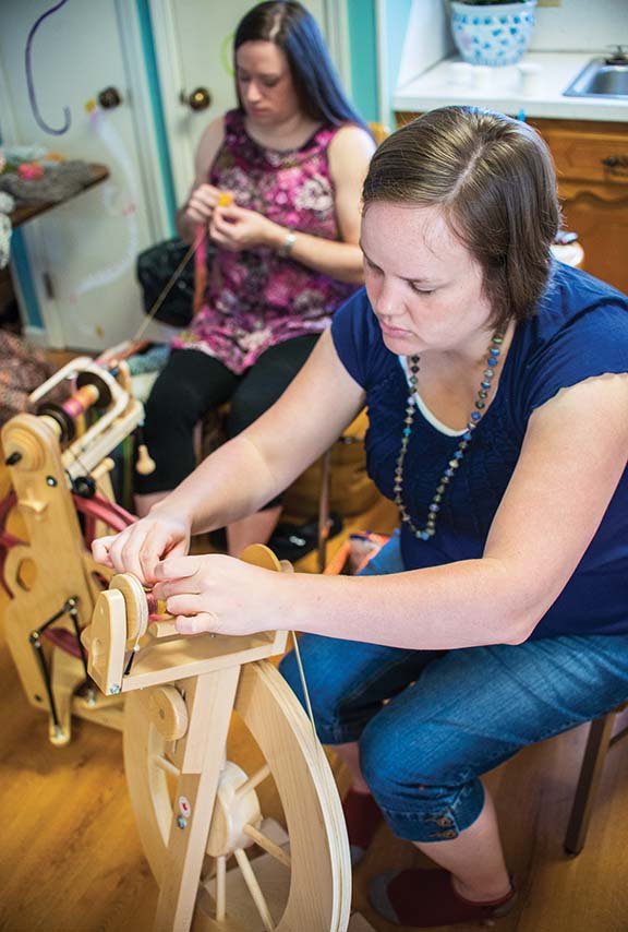 Kristi Smith, left, and Danielle Haas work on their spinning wheels at the Knit Unto Others store in Arkadelphia. The retail needlework shop offers area residents a chance to learn about the art.