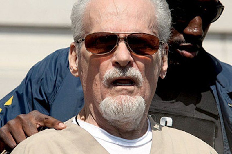 This file photo shows Tony Alamo being led from the federal courthouse in Texarkana on July 23, 2009. An insurance company is asking a Pulaski County judge to declare it has no responsibility to pay court judgments against the homeowner's policy of one of Alamo's followers.