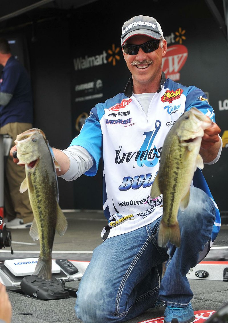 NWA Democrat-Gazette/Michael Woods --04/24/2015--w@NWAMICHAELW... Pro fisherman Andy Morgan from Dayton Tennessee holds up a pair of fish caught during day 2 of the Walmart FLW tournament on Beaver Lake. Morgan moved into 1st place for day two with a total weight of 28 pounds 9 ounces.