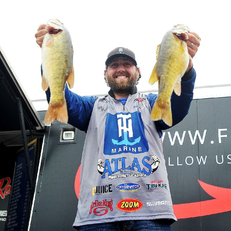 NWA Democrat-Gazette/Michael Woods --04/24/2015--w@NWAMICHAELW... Co-Angler Luke Dunkin from Lawernceburg Tennessee, shows off tow of his fish on his way to first place win in the co-angler division of the Walmart FLW tournament on Beaver Lake Friday evening. Duncan finished with a total weight of 18 pounds and 2 ounces to win $20,000.