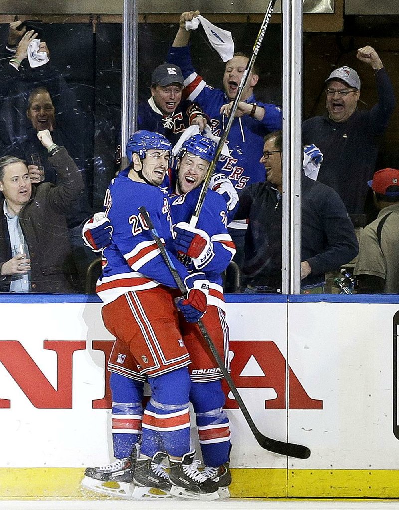 New York Rangers' Chris Kreider (20) celebrates with Derek Stepan, right, after Stepan scored a goal during the first period of Game 5 against the Pittsburgh Penguins in the first round of the NHL hockey Stanley Cup playoff, Friday, April 24, 2015, in New York. (AP Photo/Frank Franklin II)