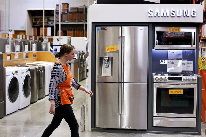 In this March 23, 2015 photo, an employee walks past a display of appliances at a Home Depot in Robinson Township, Pa. Orders for durable goods rebounded 4 percent in March after having fallen 1.4 percent in February, the Commerce Department reported Friday, April 24, 2015.  The result was led by a big jump in demand for commercial aircraft. Outside of the transportation category, orders were down for a sixth straight month.. (AP Photo/Gene J. Puskar)