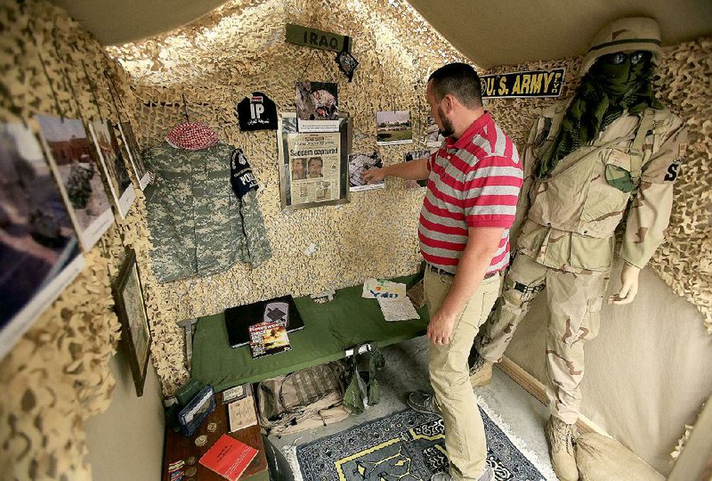 Arkansas Democrat-Gazette/STATON BREIDENTHAL --4/22/15-- Air Force veteran John Stauffer checks the Iraq war display he put together Wednesday at the Museum of Veterans and Military History in Vilonia. the museum is scheduled to reopen Saturday after the original museum was damaged in last year's tornado. 