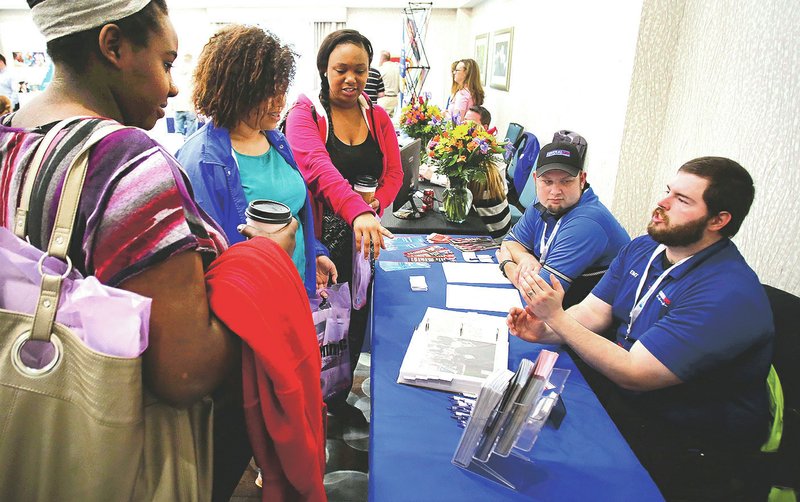 NWA Democrat-Gazette/DAVID GOTTSCHALK Skylar Cleary (from left), Destinie Daniels and Tia Lee, all juniors at Fayetteville High School, visit Friday with Mark Ramsey (right) and Dustin Sanders with Central EMS during the annual Fayetteville Job Expo at the Hilton Garden Inn in Fayetteville. The job fair, presented by Penmac, featured 46 employers, a breakfast and speakers. For photo galleries, go to nwadg.com/photos.