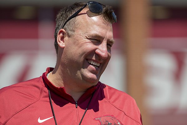 Arkansas head coach Bret Bielema laughs with a group of coaches and reporters before the Razorbacks' spring NCAA college football game, Saturday, April 25, 2015, in Fayetteville, Ark. (AP Photo/Gareth Patterson)