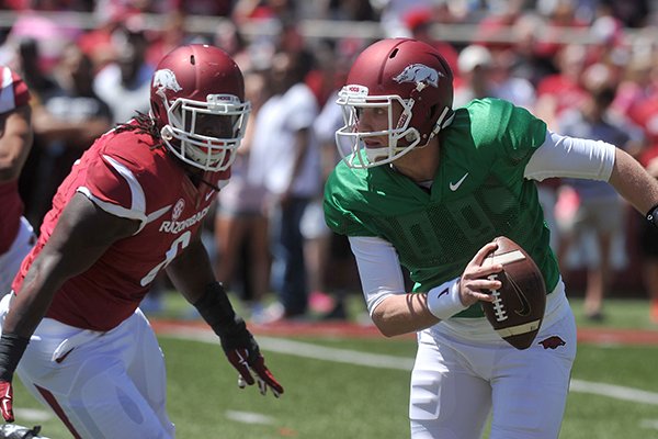 Arkansas quarterback Austin Allen is pressured by defensive end JaMichael Winston during the Razorbacks' spring game Saturday, April 25, 2015, at Razorback Stadium in Fayetteville. 