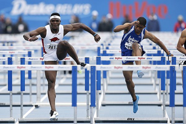 Arkansas' Omar McLeod, left, eyes the final hurdle ahead of Indiana State's Adrius Washington, right, in the men's 110-meter hurdles at the Drake Relays athletics meet, Saturday, April 25, 2015, in Des Moines, Iowa. McLeod won the event. (AP Photo/Charlie Neibergall)