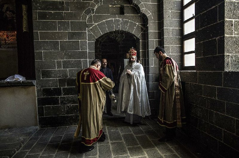 A priest prepares to administer the Easter Mass at the Surp Giragos Church in Diyarbakir, Turkey, April 5, 2015. Many ethnic Armenians who are rediscovering their roots have found it easier to discard their Kurdish or Turkish identities than to relinquish their religion. (Bryan Denton/The New York Times)