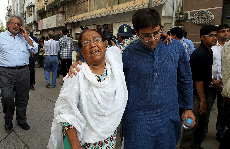 A woman mourns after attending the funeral prayers of prominent women's rights activist Sabeen Mahmud, who was killed by unknown gunmen in Karachi, Pakistan on Saturday, April 25, 2015. Gunmen on a motorcycle killed Mahmud in Pakistan just hours after she held a forum on the country's restive Baluchistan region, home to a long-running insurgency, police said Saturday. (AP Photo/Fareed Khan)