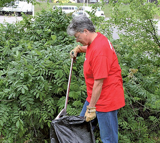 The Sentinel-Record/Elisha Morrison Cindy Barry picks up trash along the Hot Springs Creek Greenway Saturday as part of the Keep America Beautiful Great American Cleanup national event. This is the fourth year for the Hot Springs event, held in conjunction with Friends of the Parks, Hot Springs Parks and Trails and Diamond Lakes Master Naturists. Volunteers cleaned the greenway from Hot Springs Transportation Depot to Seneca Street, and Hot Springs National Park Rotary Club members installed plants at the Rotary Centennial Trailhead as part of the event.