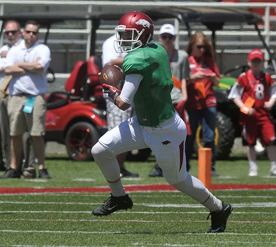 NWA Democrat-Gazette/Michael Woods BRAND OF FOOTBALL: Arkansas quarterback Brandon Allen runs the ball for a gain during the annual Red-White game Saturday afternoon at Reynolds Razorback Stadium in Fayetteville. The redshirt senior threw three touchdown passes in his final spring game.