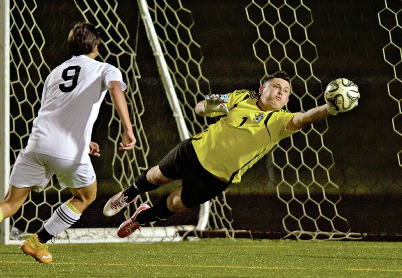 NWA Democrat-Gazette/BEN GOFF Fredy Mendez, Springdale Har-Ber goalie, makes one of his saves April 10 against Bentonville. Mendez posted the shutout to give Har-Ber a 2-0 victory over the defending state champions.