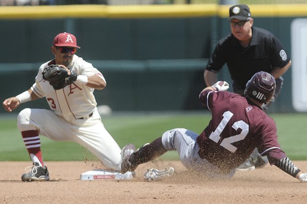 Mississippi State's Reid Humphreys makes it to second ahead of the tag by Arkansas' Michael Bernal Sunday, April 26, 2015 at Baum Stadium in Fayetteville. The Hogs lost 2-1.