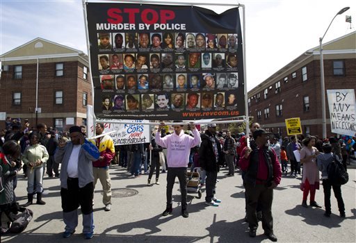 Demonstrators protest in the streets as they march for Freddie Gray to Baltimore's City Hall, Saturday, April 25, 2015. Gray died from spinal injuries about a week after he was arrested and transported in a police van. 