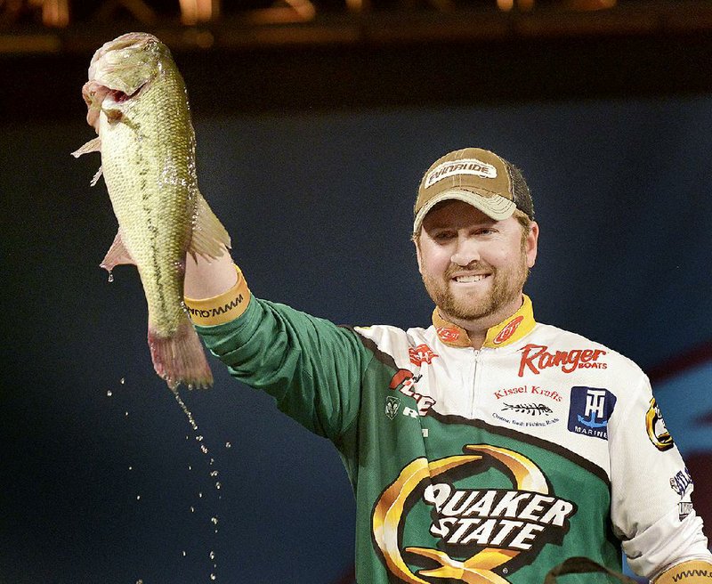 NWA Democrat-Gazette/BEN GOFF -- 04/26/15 Matt Arey, FLW pro from Shelby, N.C., holds up one of his bass during weigh-in on the final day of the Walmart FLW Tour at Beaver Lake at the John Q. Hammons Center in Rogers on Sunday Apr. 26, 2015. Arey won the event for the second year in a row with a four-day total of 55 lbs. 6 oz.