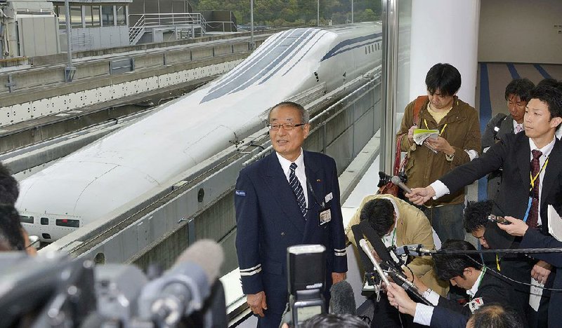 Yasukazu Endo, general manager of JR Central's Yamanashi Maglev Test Line Test Center, answers a reporter's question after a Japanese maglev train that is the fastest passenger train in the world broke its own speed record in Tsuru, about 80 kilometers (50 miles) west of Tokyo Tuesday, April 21, 2015. Operator JR Central said the train reached 603 kilometers per hour (375 miles per hour) in the test run on Tuesday, surpassing its previous record of 361 mph (581 kph) set in 2003. (Katsuya Miyagawa/Kyodo News via AP) JAPAN OUT, CREDIT MANDATORY