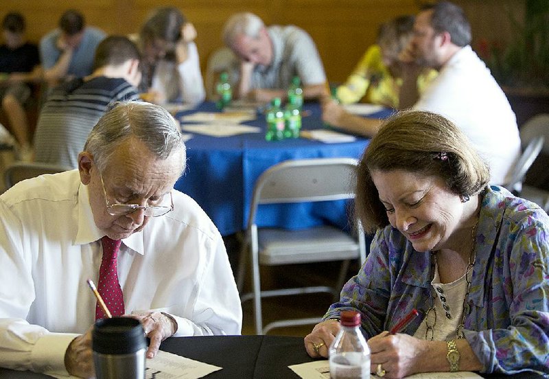 Arkansas Democrat-Gazette/MELISSA SUE GERRITS - 04/26/15 - NPR host David Miller, left, and veteran crossword contestant Sharum Dinning, work on a puzzle during the annual Crossword and Sudoku Puzzle event contest April 26, 2015 at the Clinton School. 