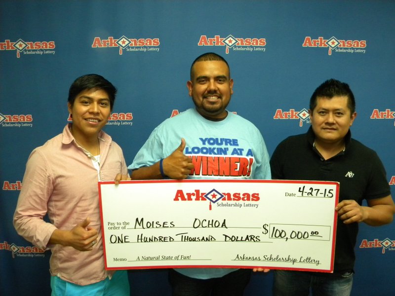 Moises Ochoa, center, along with his two friends Benito and Luis, shows off his $100,000 Arkansas Scholarship Lottery winnings. 