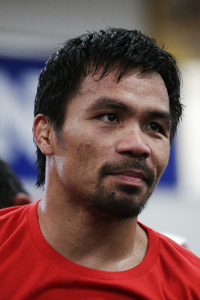 Boxer Manny Pacquiao, of the Philippines, stands on the canvas during his workout at Wild Card Boxing Club, Monday, April 27, 2015, in Los Angeles. Pacquiao is scheduled to fight Floyd Mayweather Jr. in a welterweight boxing match in Las Vegas Saturday. (AP Photo/Jae C. Hong)