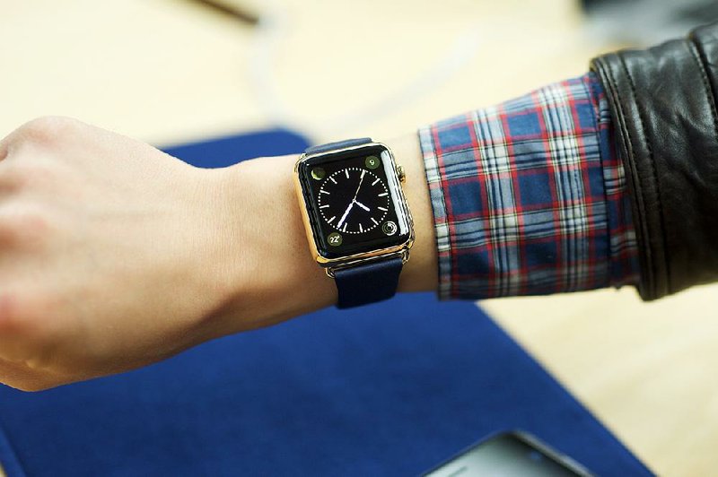 IMAGE DISTRIBUTED FOR APPLE - An excited customer tries on the Apple Watch Edition at the Eaton Centre Apple Store on Friday, April 10, 2015 in Toronto. (Photo by Ryan Emberley/Invision for Apple/AP Images)