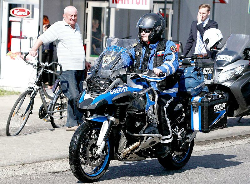 A Russian biker who crosses into Poland at the border crossing with Belarus, in Terespol, Poland, on Monday, April 27, 2015, as one in a group of Russian bikers who are going from Moscow to Berlin to mark the 70th anniversary of Soviet victory over Nazi Germany. Their planned passage through Poland has provoked controversy because it is to include members of pro-Kremlin Night Wolves group, who have been banned from entering Poland. (AP Photo/Czarek Sokolowski)