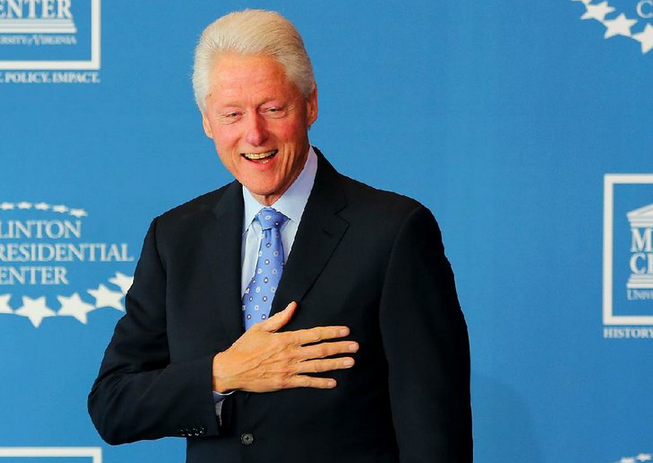 Former President Bill Clinton holds his hand to his heart at the Clinton Presidential Center in Little Rock in this Nov. 14, 2014 file photo. 