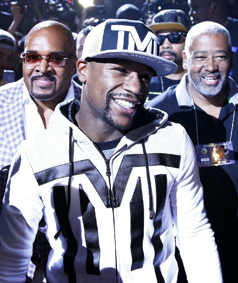 Boxer Floyd Mayweather Jr. walks to the stage during an arrival ceremony Tuesday, April 28, 2015, in Las Vegas. Mayweather will face Manny Pacquiao in a welterweight boxing match in Las Vegas on May 2. 
