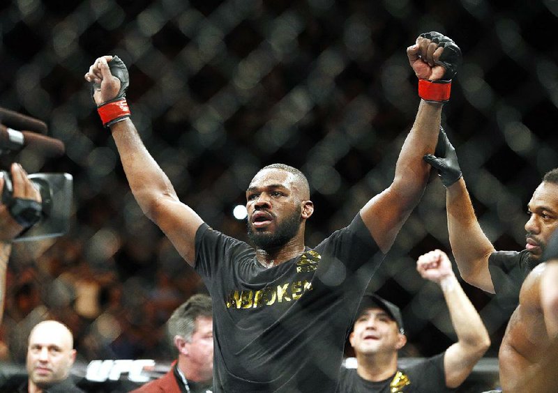 This Jan. 3, 2015, file photo shows Jon Jones celebrates after defeating Daniel Cormier during their light heavyweight title mixed martial arts bout in Las Vegas. Albuquerque police were searching for UFC light heavyweight champion Jones on Sunday night, April 26, 2015, in connection with a hit-and-run accident. 