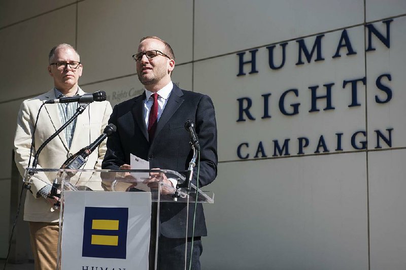 Chad Griffin, Human Rights Campaign President, with Jim Obergefell, left, speaks at a news conference outside the headquarters of the Human Rights Campaign on Monday, April 27, 2015 in Washington. Obergefell is the named plaintiff in the marriage equality case before the Supreme Court. 